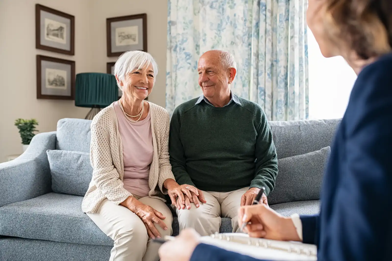 An older couple meeting a care professional in their sitting room